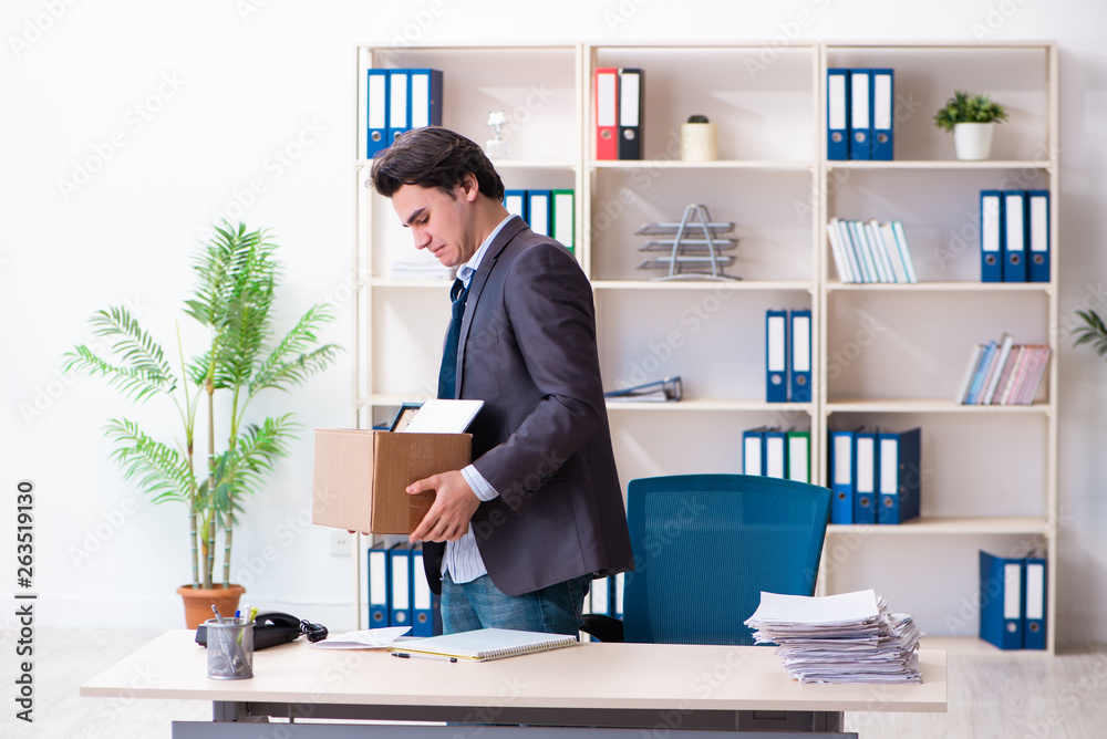 Young male employee being fired from his work Young male employee being fired from his work