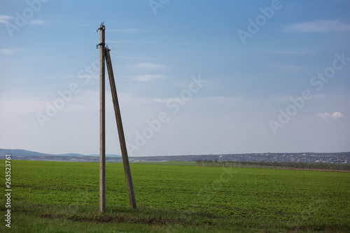 Stone electric pole in agriculture field.