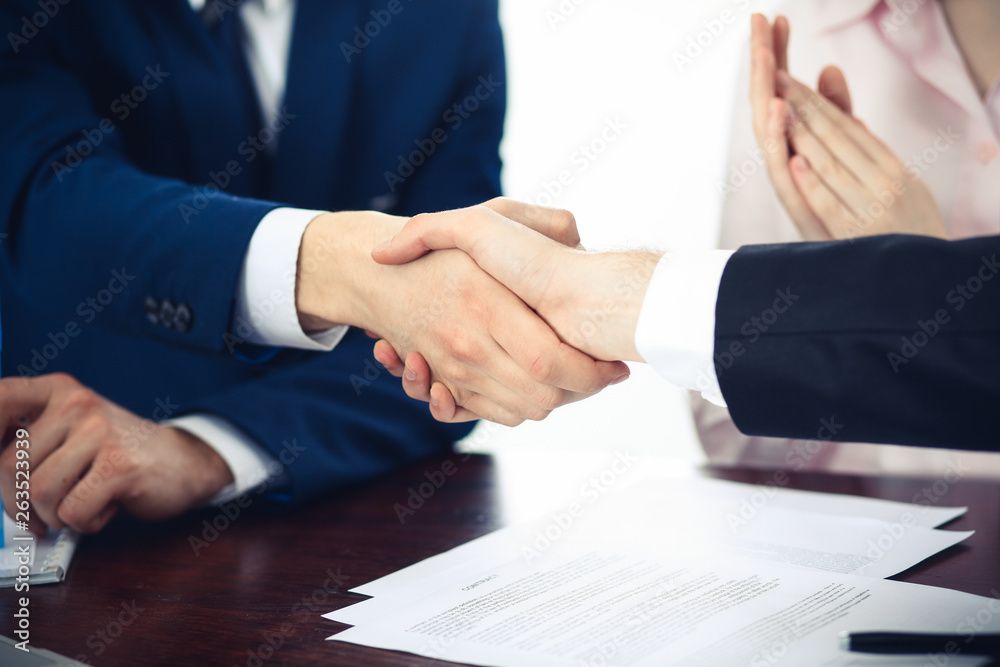 Business people shaking hands finishing up a meeting. Handshake at successful negotiation Business people shaking hands finishing up a meeting. Handshake at successful negotiation
