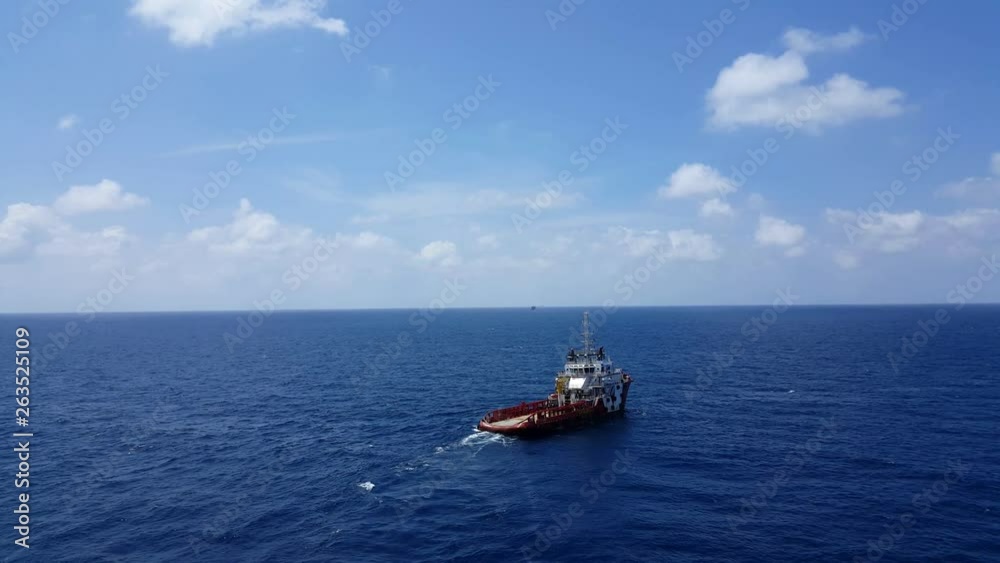 Songkhla, Thailand-February 15, 2019 : Red Supply boat transfer cargo to oil and gas industry and moving cargo from the boat to the platform. Boat is waiting transfer cargo and crews to platform. Songkhla, Thailand-February 15, 2019 : Red Supply boat transfer cargo to oil and gas industry and moving cargo from the boat to the platform. Boat is waiting transfer cargo and crews to platform.