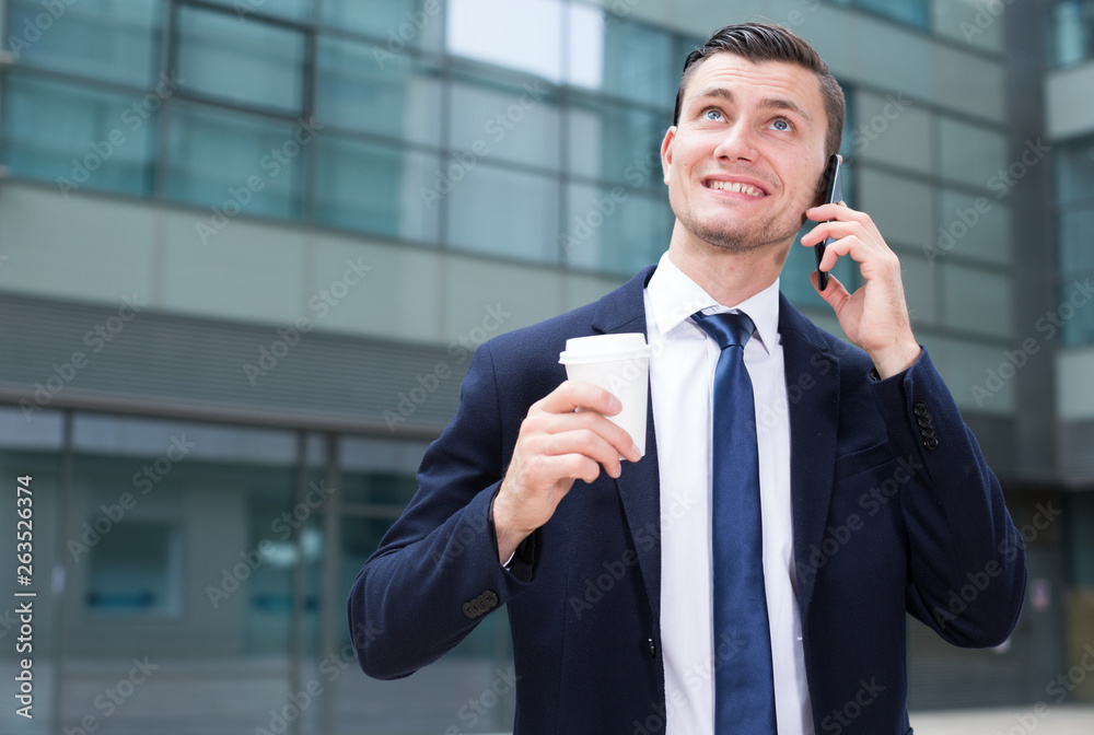 Fototapeta premium Professional businessman is drinking coffee and talking phone