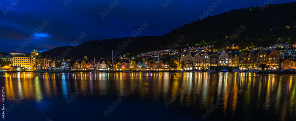 Wide night cityscape of the iconic Bergen harbour ad Bryggen historic district, Norway
