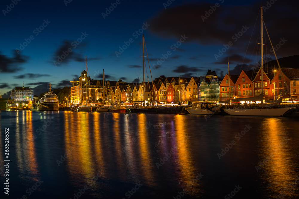 Scenic view at sunset of Bergen harbour and Bryggen waterfront, famous for its historic wooden houses part of UNESO World Heritage Site, Norway