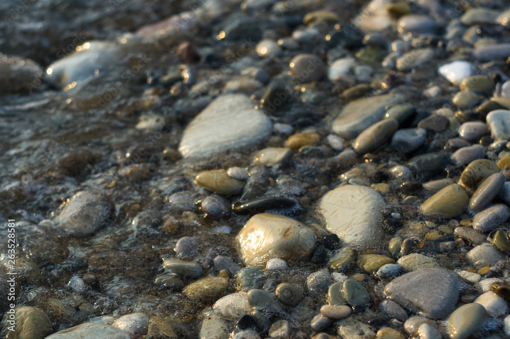 pebble stones on the sea beach, the rolling waves of the sea with foam pebble stones on the sea beach, the rolling waves of the sea with foam