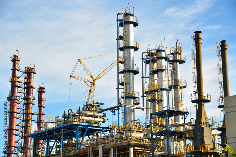 Close-up of pipelines and destillation tanks of an oil-refinery plant Close-up of pipelines and destillation tanks of an oil-refinery plant