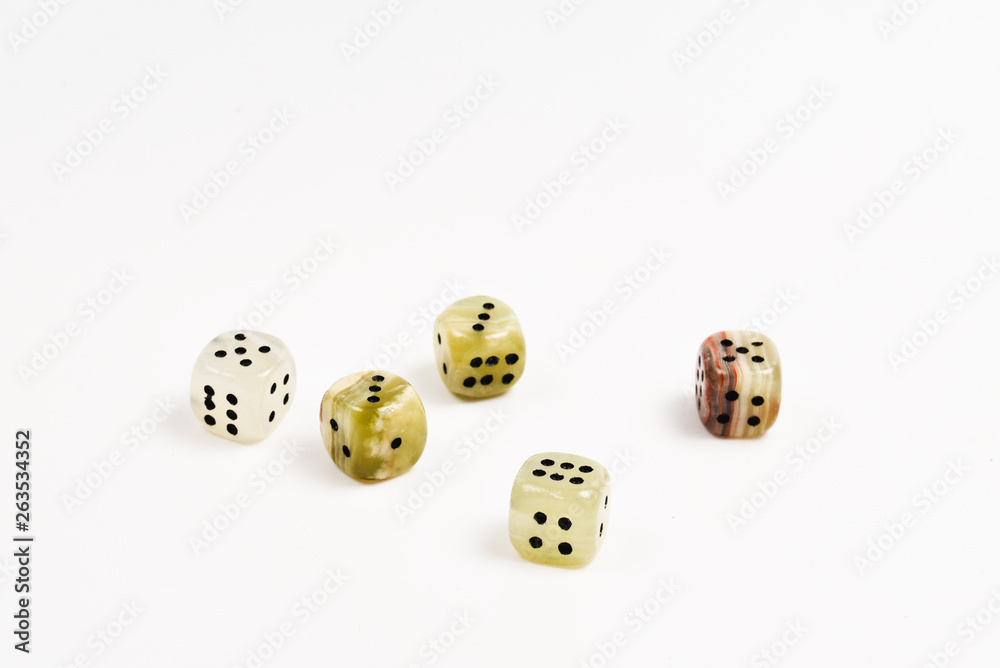 Dices made of natural stone on a white background. Copy space. Gaming. Dices made of natural stone on a white background. Copy space. Gaming.