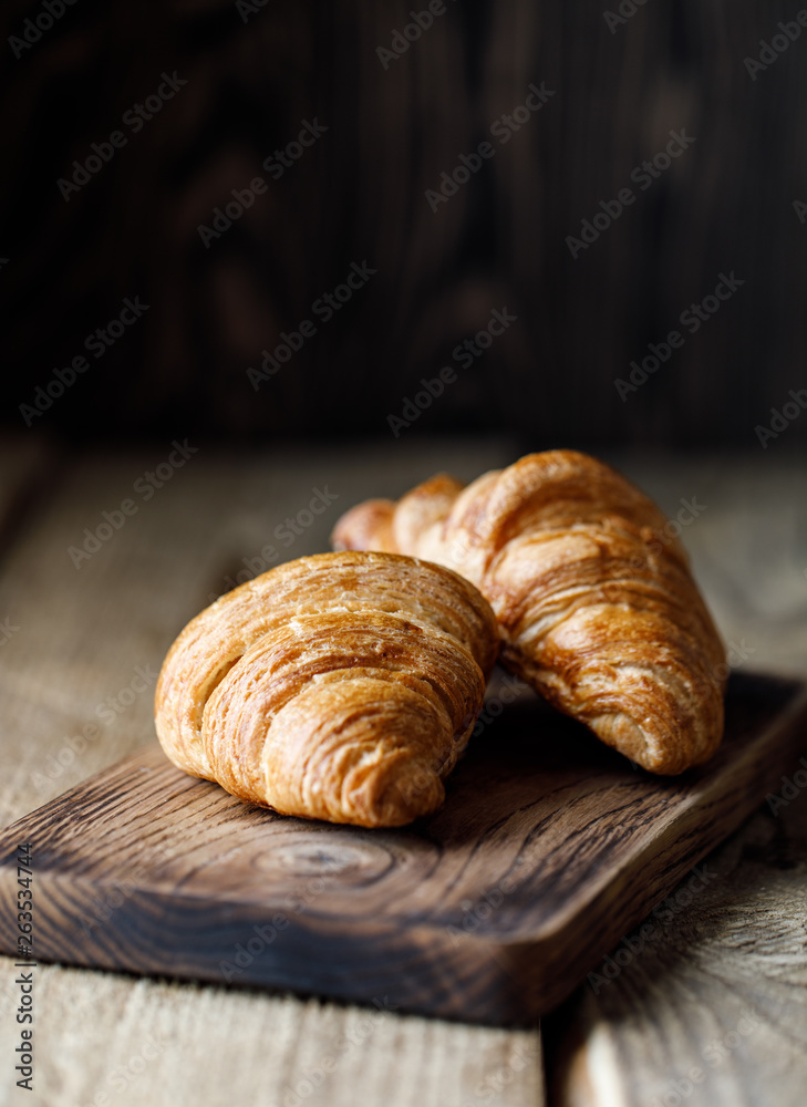 Freshly baked croissants on wooden rustic background. Tasty croissants with copy space Freshly baked croissants on wooden rustic background. Tasty croissants with copy space