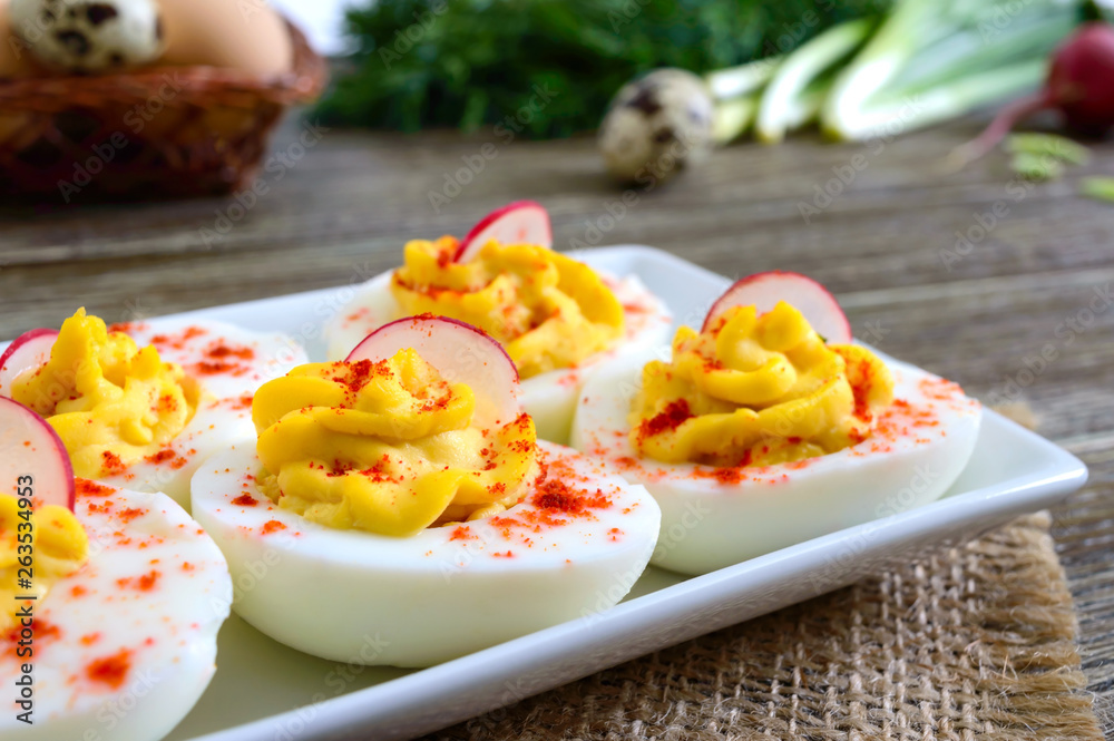 Deviled eggs. Delicious appetizer. Boiled eggs stuffed with yolk, mustard, mayonnaise, paprika. Classic recipe. Deviled eggs. Delicious appetizer. Boiled eggs stuffed with yolk, mustard, mayonnaise, paprika. Classic recipe.