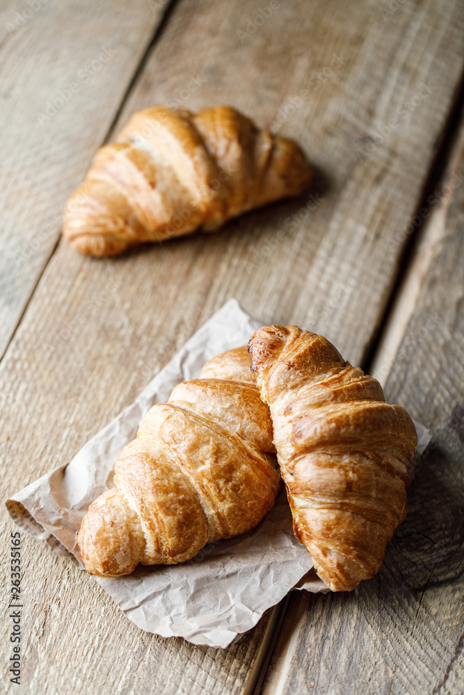 Freshly baked croissants with jam on wooden rustic background. Tasty croissants with copy space Freshly baked croissants with jam on wooden rustic background. Tasty croissants with copy space