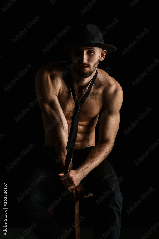 Muscular male bodybuilder on black background Muscular male bodybuilder on black background
