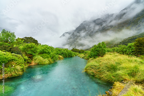 wooden bridge over river in the mountains in the rain  new zealand 13