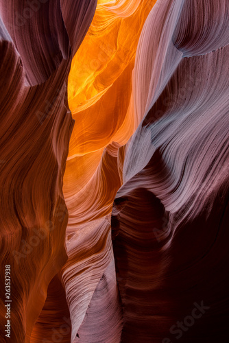 The golden orange light gives off a magical glow on the canyon walls on a southern Utah slot canyon geological area Between Page AZ and Kanab UT. the slot canyons of Arizona Desert are amazing