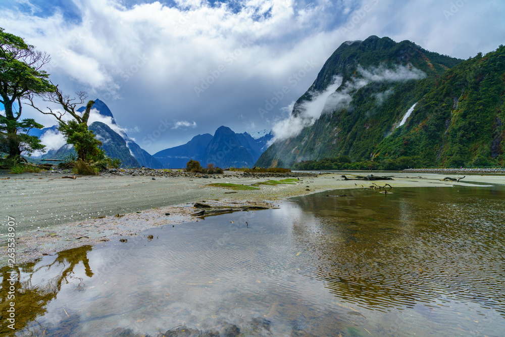 reflections of mountains in the water, milford sound, new zealand 9
