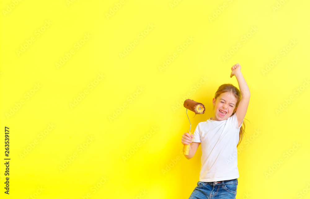 funny little girl with a paint roller for painting rejoices and has fun near the painted wall. Repair in the apartment. funny little girl with a paint roller for painting rejoices and has fun near the painted wall. Repair in the apartment.