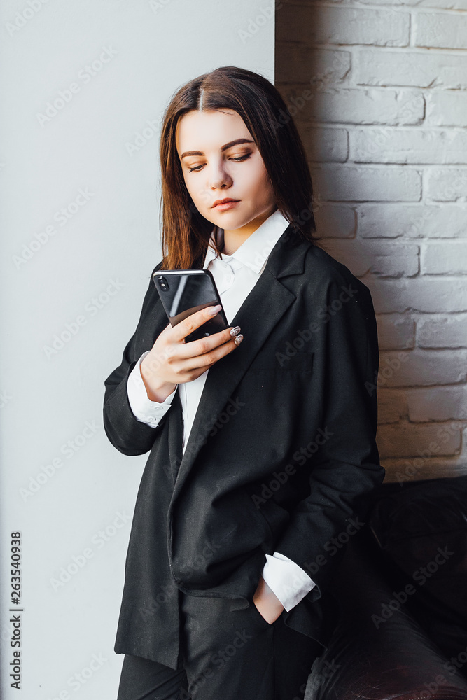 Gorgeous female reading news via network on mobile phone while waiting for her partners in modern coffee shop! Gorgeous female reading news via network on mobile phone while waiting for her partners in modern coffee shop!