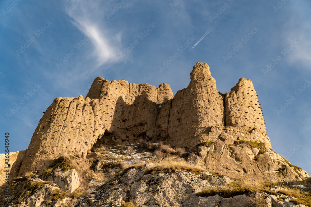 Ancient castle of Van in Turkey, known also as Tushba Castle. Airplane on the sky.