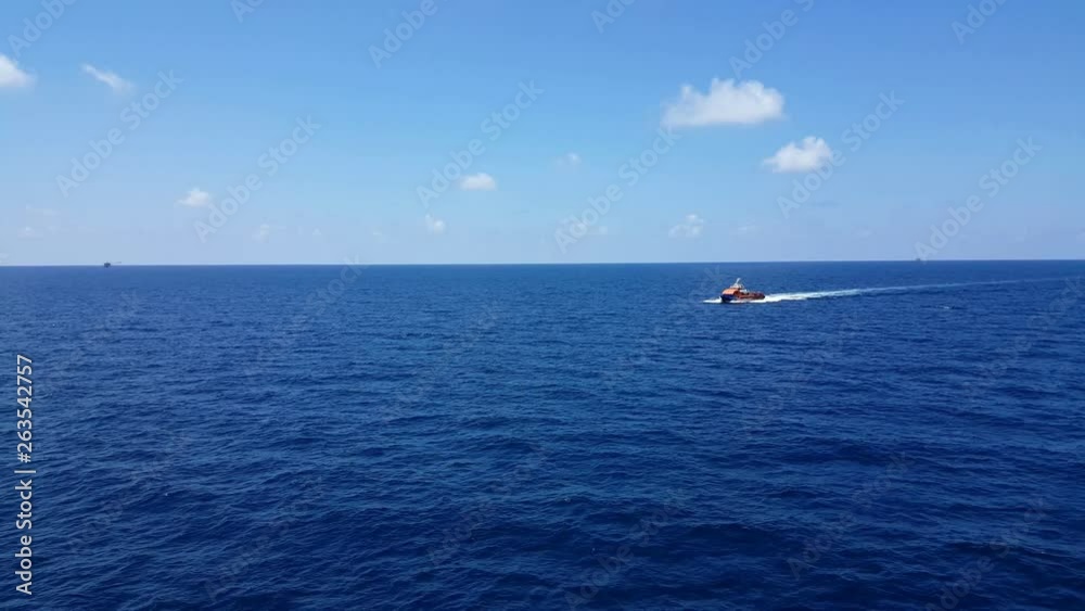 Songkhla, Thailand-February 19, 2019 : Red Supply boat transfer cargo to oil and gas industry and moving cargo from the boat to the platform. Boat is waiting transfer cargo and crews to platform. Songkhla, Thailand-February 19, 2019 : Red Supply boat transfer cargo to oil and gas industry and moving cargo from the boat to the platform. Boat is waiting transfer cargo and crews to platform.