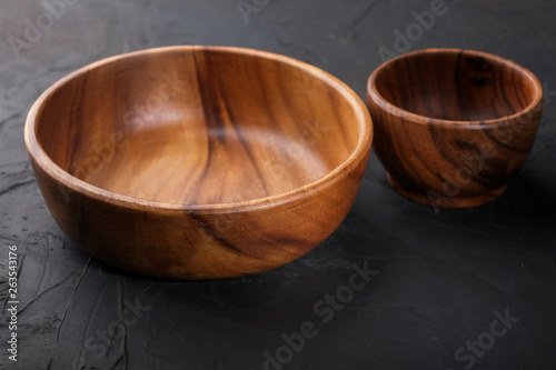 Tableware made of wood on a dark background.