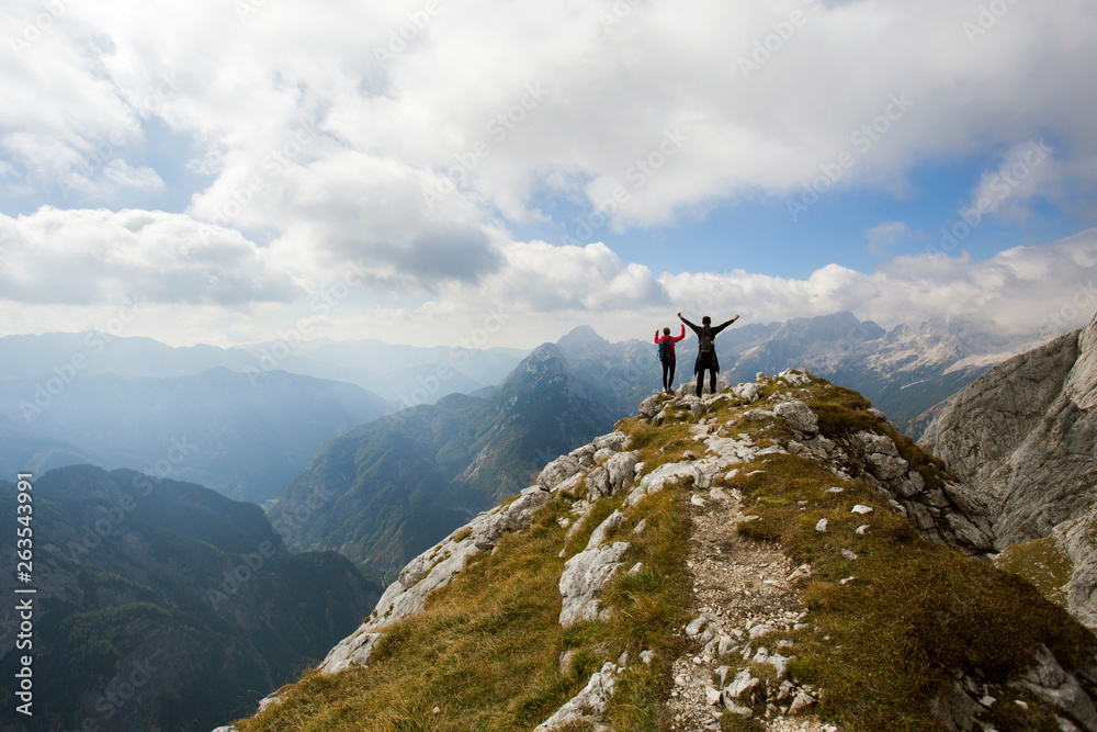 Hikers on hill under Prisojnik peak, Julian Alps, Slovenia. Hikers on hill under Prisojnik peak, Julian Alps, Slovenia.