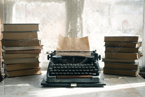 Принти на полотні Typewriter and stack of books on a writer table background.
