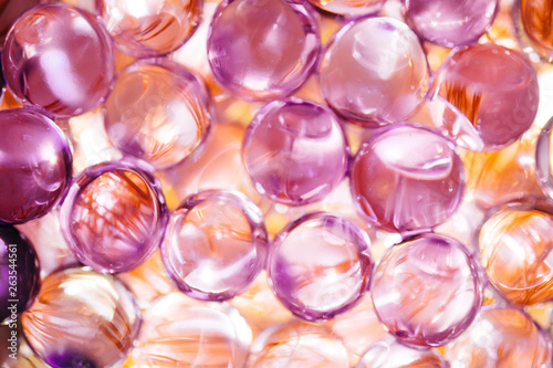 Abstract background with shiny water balls in violet and orange colors