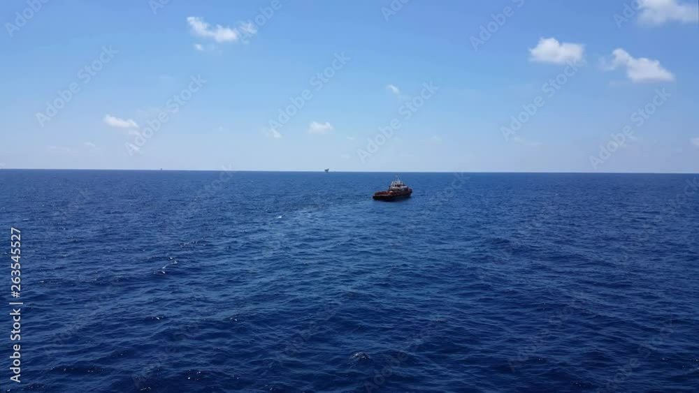 Songkhla, Thailand-February 19, 2019 : Red Supply boat transfer cargo to oil and gas industry and moving cargo from the boat to the platform. Boat is waiting transfer cargo and crews to platform. Songkhla, Thailand-February 19, 2019 : Red Supply boat transfer cargo to oil and gas industry and moving cargo from the boat to the platform. Boat is waiting transfer cargo and crews to platform.