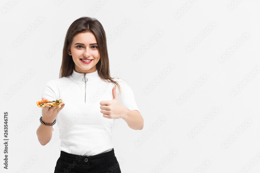 Photo of attractive woman eats slice of pizza, points aside with thumb, dressed in fashionable clothes, Photo of attractive woman eats slice of pizza, points aside with thumb, dressed in fashionable clothes,