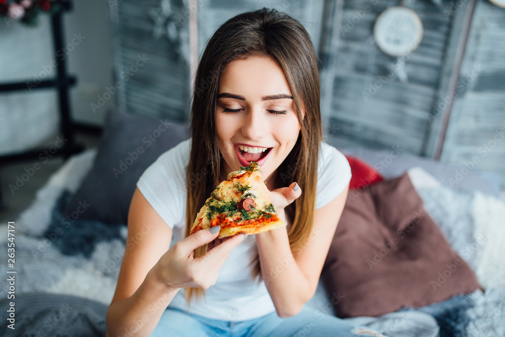 Beautiful close-up portrait of young woman eating pizza. Healthy and junk food concept. Diet! Beautiful close-up portrait of young woman eating pizza. Healthy and junk food concept. Diet!