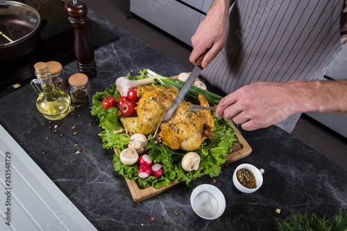 Tasty delicious food on wooden desk in kitchen. Grilled chicken or turkey with spices and fresh vegetables. Christmas or thanksgiving pay preparation
