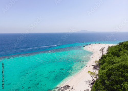 Fototapeta Naklejka Na Ścianę i Meble -  Aerial view of the beach on an island in the blue ocean