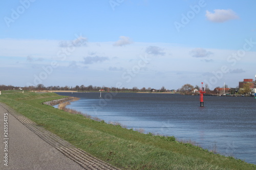 Red guiding post in the river Hollandsche IJssel to mark the safe waterway in the water