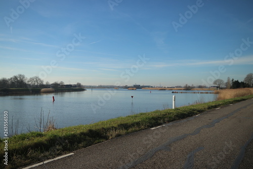 Blue sky and sun over the River Hollandsche IJssel at Moordrecht in the Netherlands