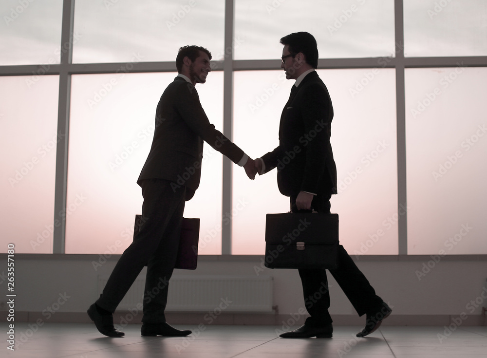 two business people holding out their hands for a handshake two business people holding out their hands for a handshake