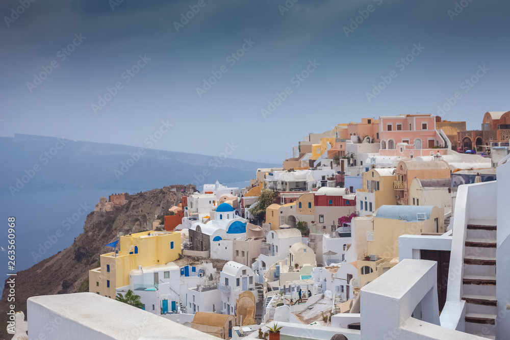 Panorama of colorful village of Oia on a rare rainy day
