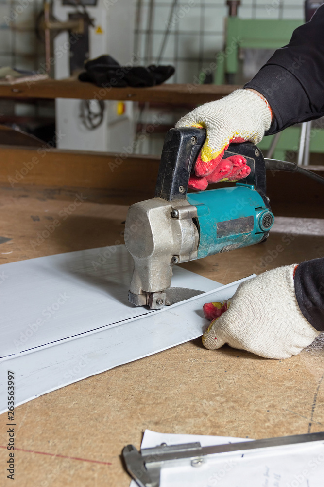 Sheet Metal Cutting Electric Shears. Cutting of metal sheets with