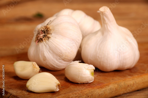 Garlic. sliced garlic  garlic clove  garlic bulb in wooden bowl place on chopping block on vintage wooden background.