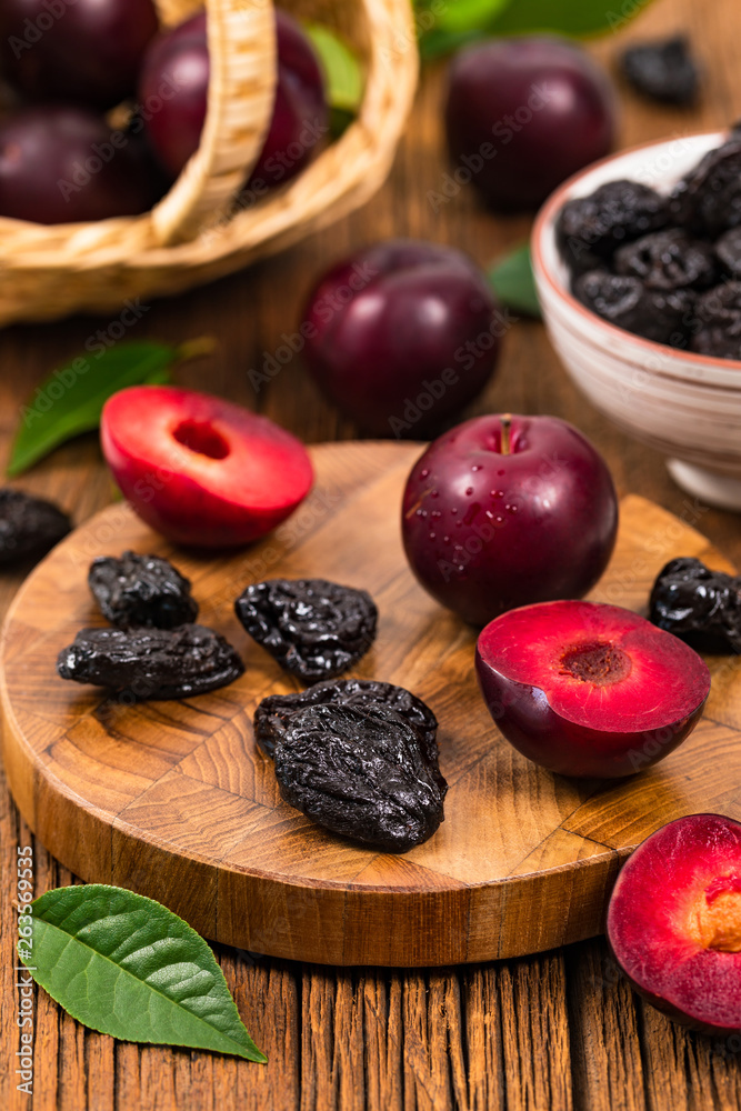 Dried Plums Pitted Prunes and Fresh Plums. Selective focus.