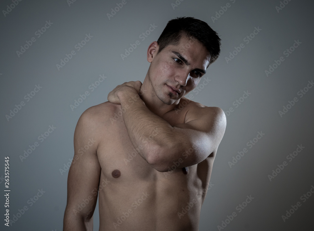 Strong young man suffering neck and cervical pain Strong young man suffering neck and cervical pain