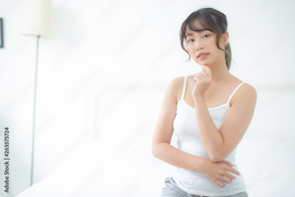 Portrait of beautiful young asian woman smile while wake up healthy and wellness with sunrise at morning in the bedroom, asia girl skin care with happy with fresh, lifestyle and relax concept. Portrait of beautiful young asian woman smile while wake up healthy and wellness with sunrise at morning in the bedroom, asia girl skin care with happy with fresh, lifestyle and relax concept.