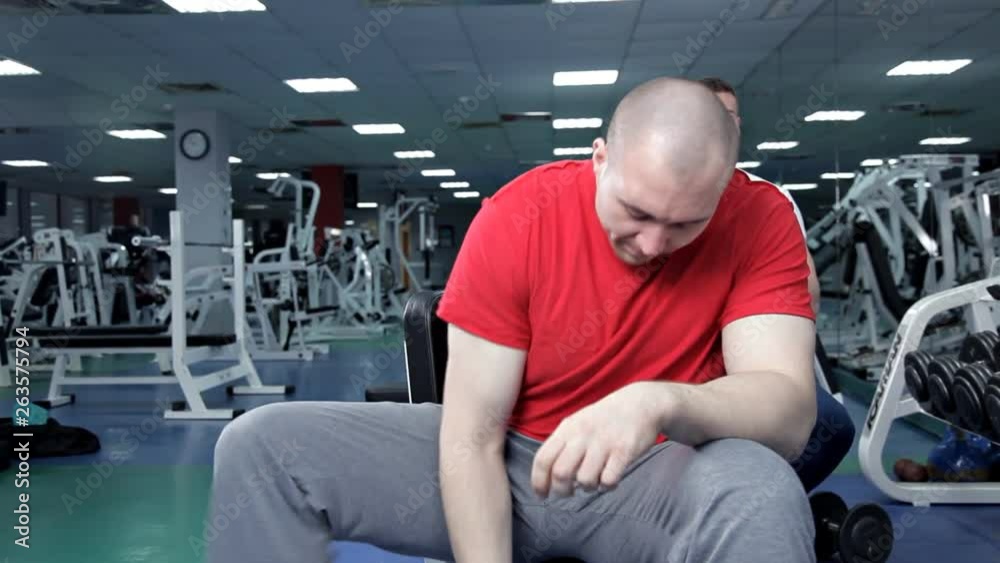 Strong handsome athletic man doing weightlifting and exercising biceps. Dumbbells Strong handsome athletic man doing weightlifting and exercising biceps. Dumbbells