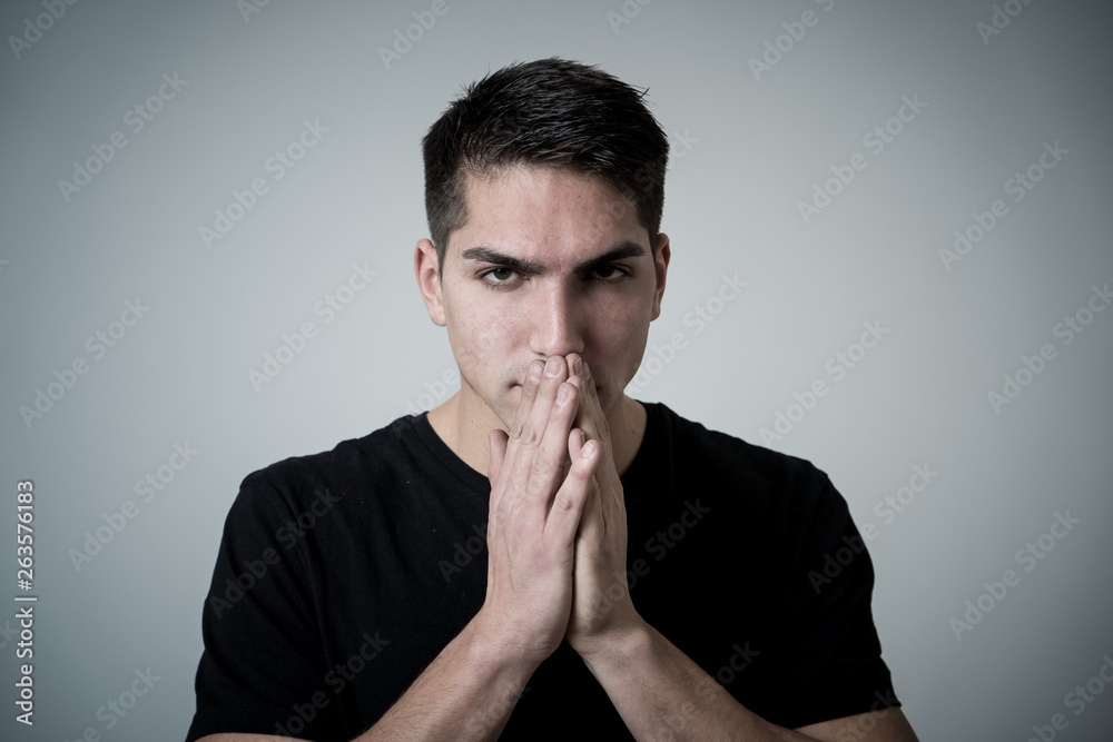 Portrait of sad and depressed young man feeling upset. Human expressions and negative emotions Portrait of sad and depressed young man feeling upset. Human expressions and negative emotions