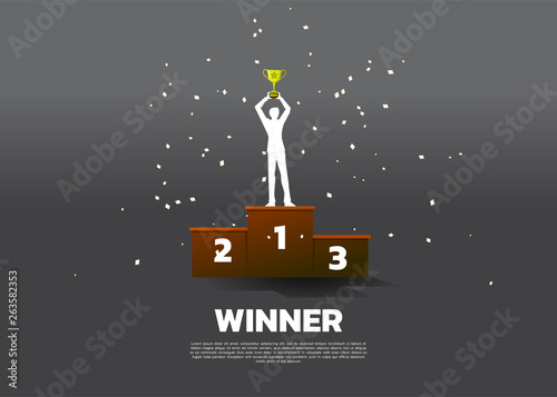 Silhouette of businessman with champion trophy on first place podium. Business Concept of winner and success