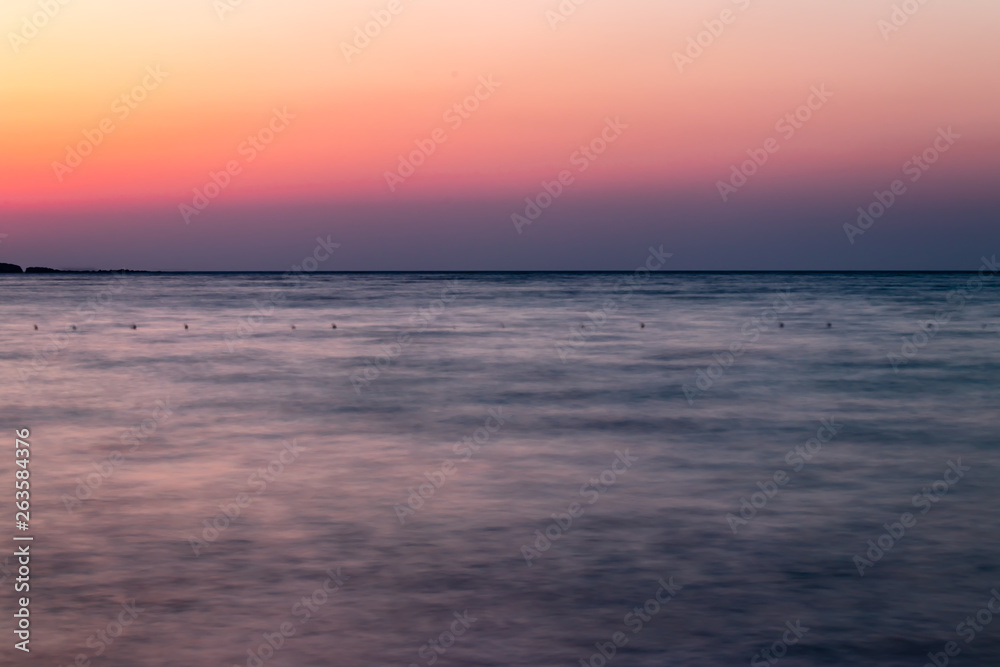 a long exposure wide landscape shoot of sea at sunset with good colors very smooth shoot
