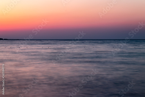 a long exposure wide landscape shoot of sea at sunset with good colors very smooth shoot