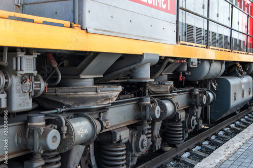 Chassis of the locomotive. The wheels of a modern locomotive. The concept of the transport industry. Heavy wheels and mechanism under the electric train