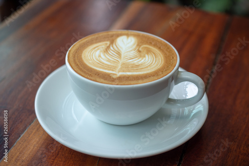 People are drinking a latte in a coffee shop.