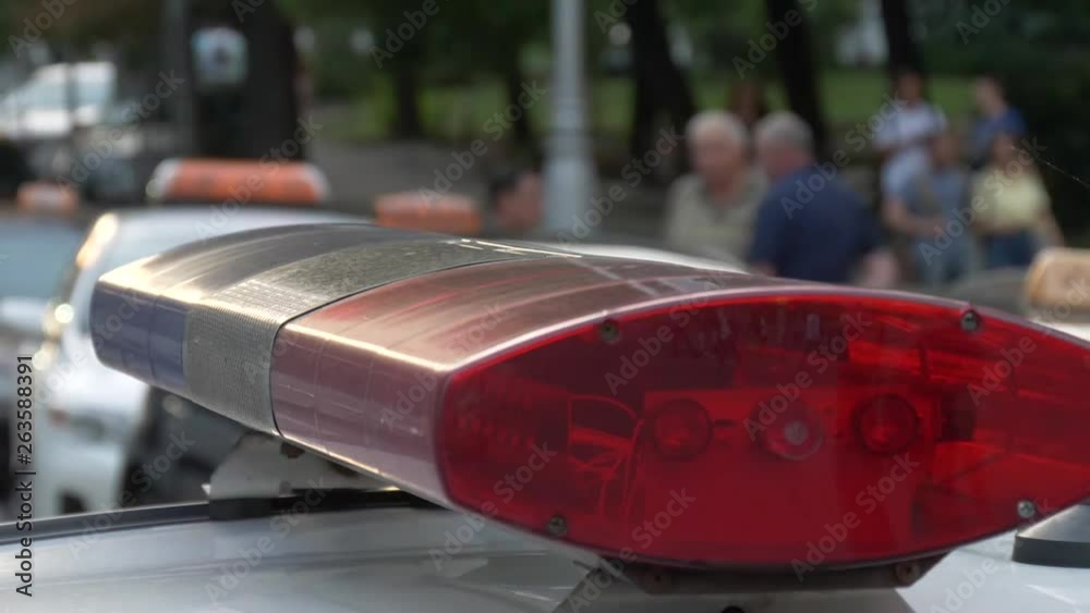 Police blue and red flashing lights on the city street, closeup