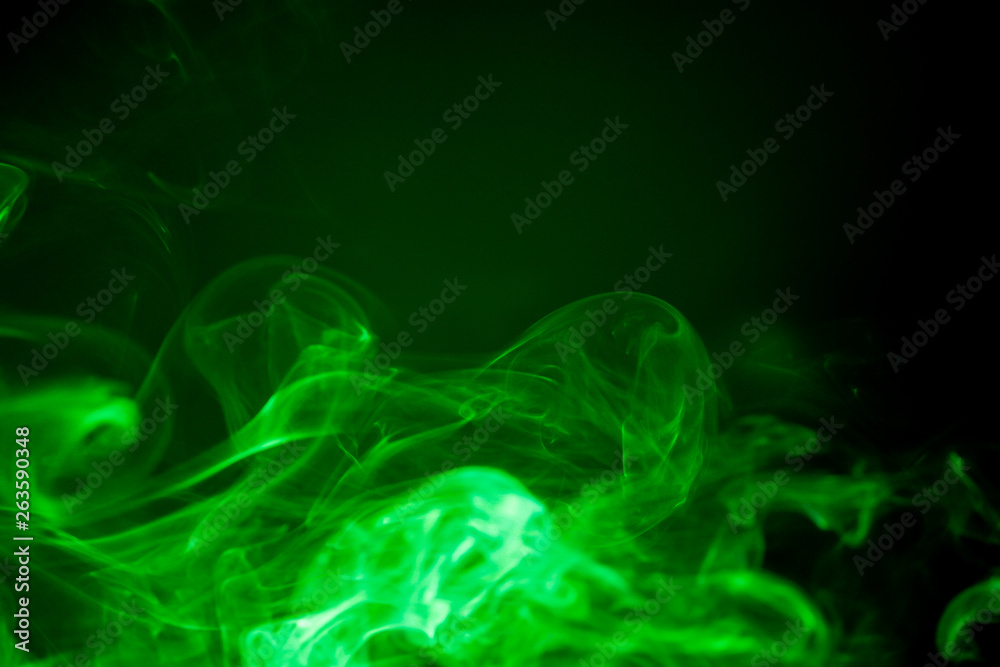 Obraz premium Green smoke motion on black background.