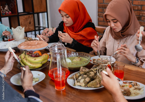 asian muslim people having dinner break fasting together at home during ramadan