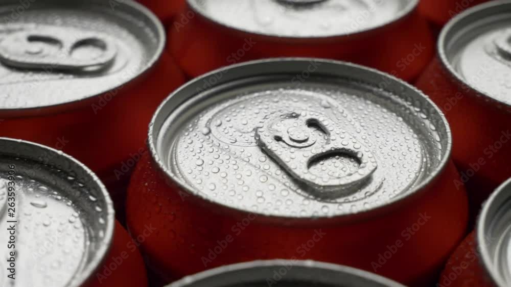 top view water droplets on red can of soda or beer rotate background. Slow motion video dolly crane shot medium extreme close up panorama high angle telephoto lens top view water droplets on red can of soda or beer rotate background. Slow motion video dolly crane shot medium extreme close up panorama high angle telephoto lens